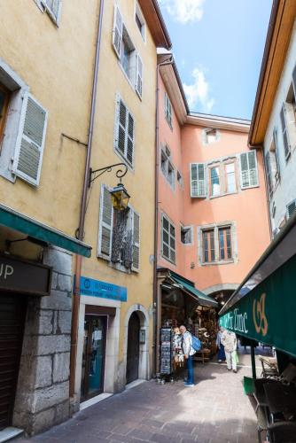 a group of buildings with people walking down a street at Le Parmelan - apartment for 2 people in the heart of the old town in Annecy