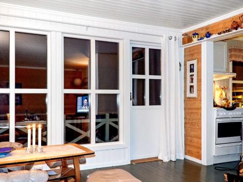 a living room with white doors and a table at 6 person holiday home in Olderdalen in Olderdalen