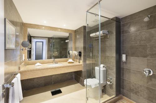La salle de bains est pourvue d'un lavabo et d'une douche. dans l'établissement Rhactus Hotel, New Alamein, à El Alamein