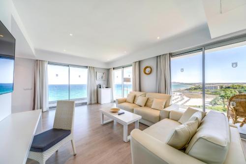 a living room with a couch and a table at Playa Esperanza Resort Affiliated by Meliá in Playa de Muro