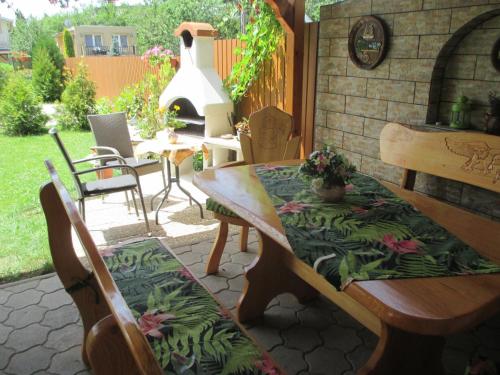 a patio with a table and chairs and a grill at Riviera Apartman in Hajdúszoboszló