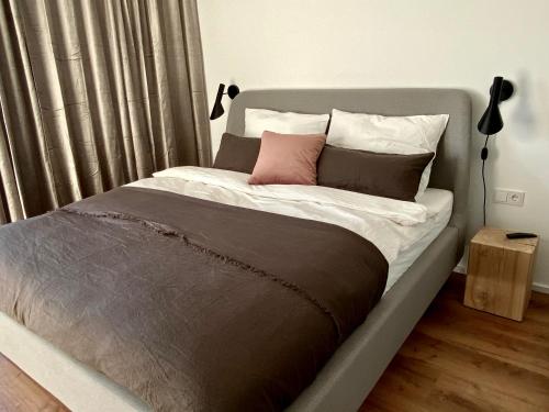 a bed with two pillows on it in a bedroom at hey BEACHVILLA in Hohwacht