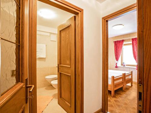 a bathroom with a toilet and a sink at Ciasa Lino Sas da le Undesc in Pozza di Fassa