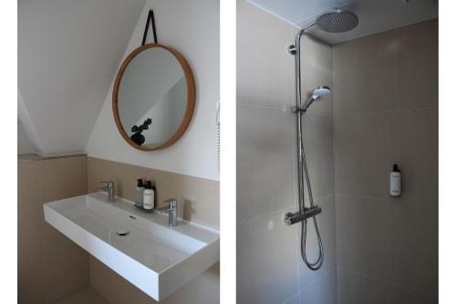 a bathroom with a shower and a sink and a mirror at Hotel Paradis Zandvoort in Zandvoort