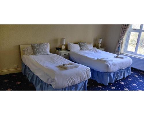 A bed or beds in a room at Limes Country House Hotel 