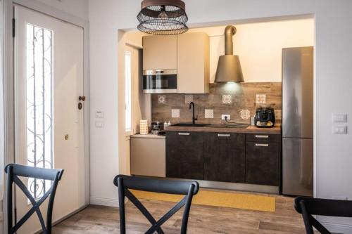 a kitchen with a stainless steel refrigerator and cabinets at Trevisi27 in Treviso