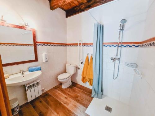 a bathroom with a toilet and a sink and a shower at El Molino de la Pastora in Valacloche