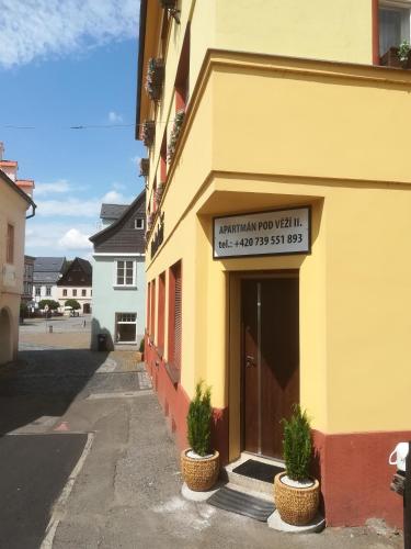 a building with a sign on the side of it at Apartmán Pod věží II in Česká Kamenice