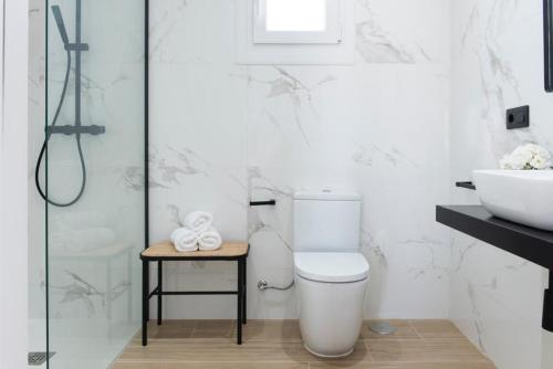 a white bathroom with a toilet and a sink at 2Casas in Pontevedra