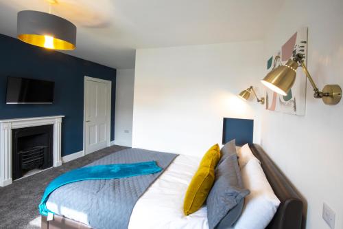 a bedroom with a bed and a fireplace at BrickSage Rooms, King's Lynn South Gate in Kings Lynn