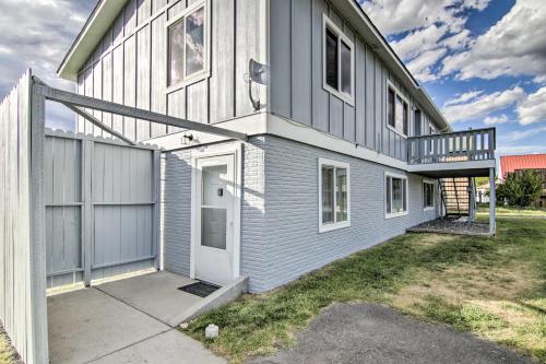 a gray house with a white door and a yard at Montanas Emigrant Peaks Getaway Apt with Mtn Views in Emigrant
