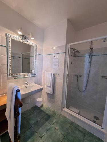 a bathroom with a sink and a shower at STELLA MARE in Algajola