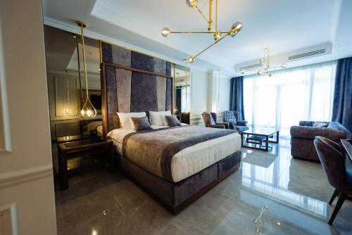 a bedroom with a large bed and a living room at Vila 6 Neptun Olimp in Olimp