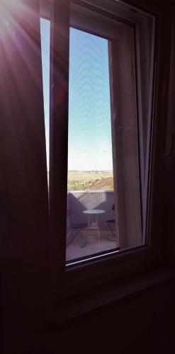 a window in a room with a view of a patio at AMARE MATERA comfortable rooms in Matera