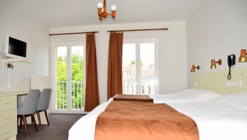 a bedroom with a large bed and a balcony at Hotel des Lauriers Roses in Bourbonne-les-Bains