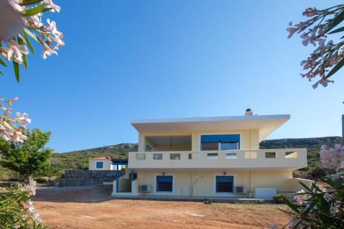 a large white house on top of a hill at Elafonisos Amazing View in Elafonisos