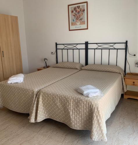 a bedroom with two beds in a room at Aparthotel Iris in Malgrat de Mar