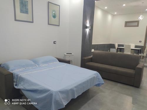 Habitación hospital con cama y sofá en MONOLOCALE-ALI', en Alì
