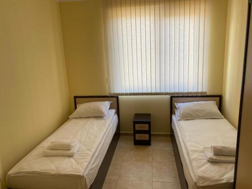 A bed or beds in a room at 3 Room Family Apartment with Pool View (4 min. away from the Sea)