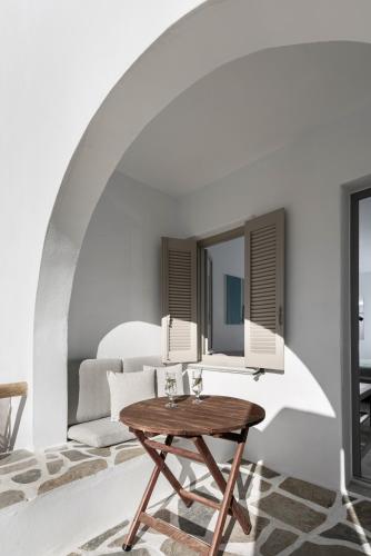 a living room with a table and a couch at Argo Boutique Hotel in Naxos Chora