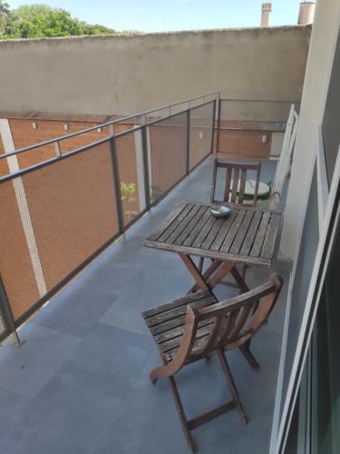a table and a chair on a balcony at Apartment close to the beach with free parking in Badalona