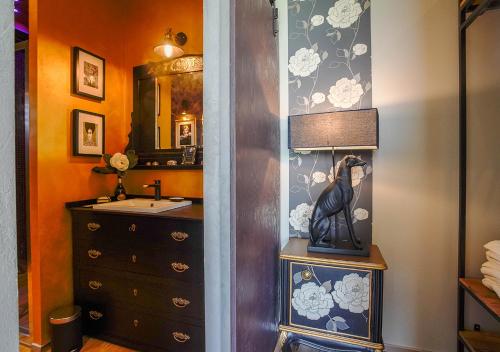 a bathroom with a sink and a dresser with a mirror at The Lake House in Viverone