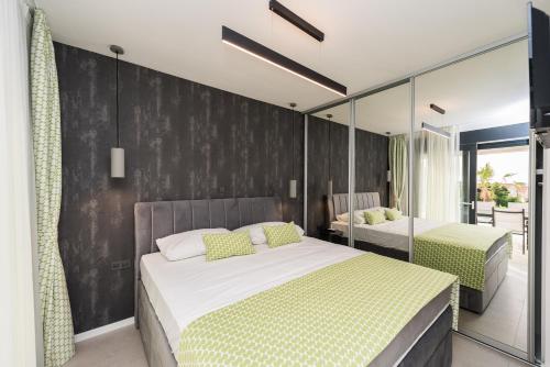 - une chambre avec 2 lits et un mur noir dans l'établissement Luxury Villas Joy, à Novalja