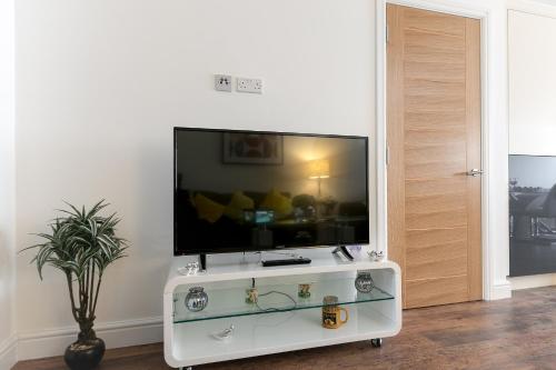 a flat screen tv sitting on top of a white entertainment center at KVM - City Apartments in Peterborough