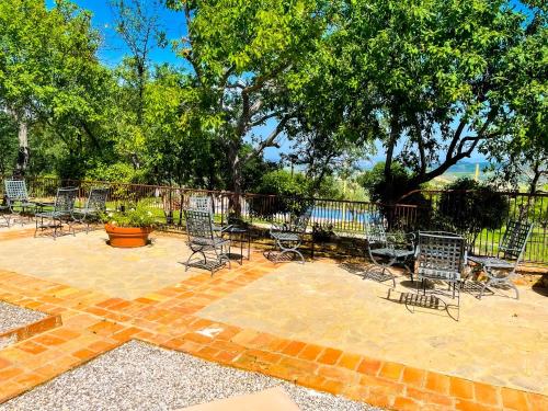 a group of chairs and tables on a brick patio at LaChiusa Tuscany in Montefollonico