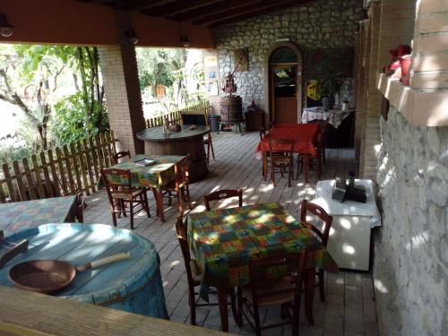 an outdoor patio with tables and chairs and a table at B&B Cagnona in Borghi