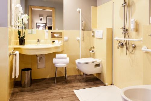 a bathroom with a toilet and a sink at Holiday Inn Milan Garibaldi Station by IHG in Milan
