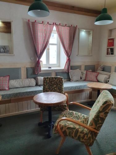 a living room with a couch and a table and chairs at Stará škola in Dolní Malá Úpa