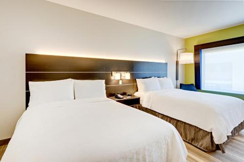 a hotel room with two beds and a window at Holiday Inn Express & Suites - Winston - Salem SW - Clemmons by IHG in Clemmons
