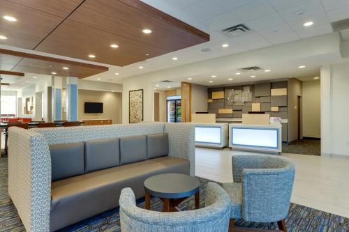 a lobby with a couch and chairs and a table at Holiday Inn Express & Suites - Winston - Salem SW - Clemmons by IHG in Clemmons