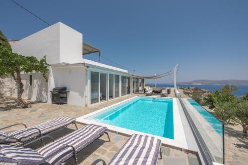 a villa with a swimming pool and a house at Villa Luna Private Heated Hydro Pool BBQ Beach 4min in Agia Marina Mikrolimanou