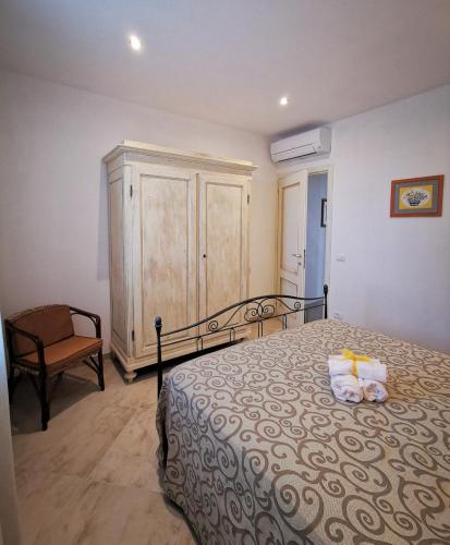 a bedroom with a bed and a cabinet and a chair at Agriturismo Sotto la Rocca in Carmignano