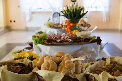 a table topped with different types of sandwiches and pastries at Pensjonat pod Giewontem in Zakopane