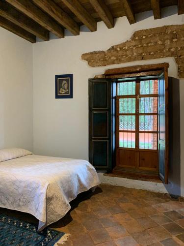 Postel nebo postele na pokoji v ubytování Antigua Hacienda Metepec
