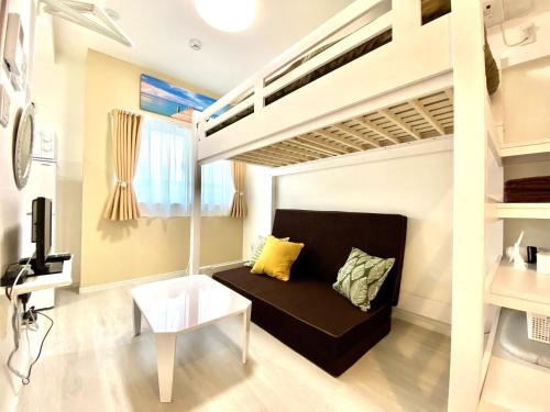a living room with a bunk bed and a table at Le Soleil Asato - Vacation STAY 48630v in Naha