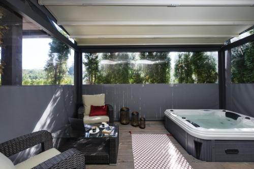 a jacuzzi tub on the back patio of a house at Lakeside Hotel Plitvice in Plitvička Jezera