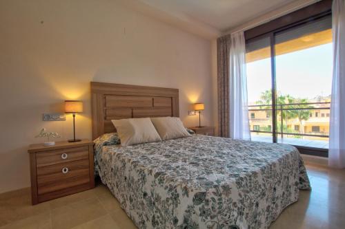 a bedroom with a bed and a large window at CALANOVA Sea Golf Paradise in Mijas