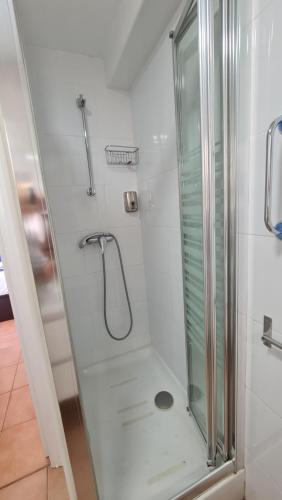 a bathroom with a shower with a glass door at Apartamento Cabrera Burriac in Cabrera de Mar