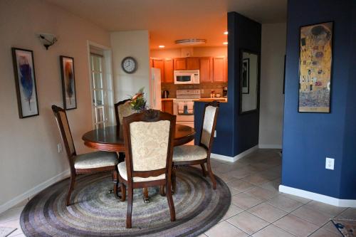 a kitchen and dining room with a table and chairs at The Adamina in Fairbanks