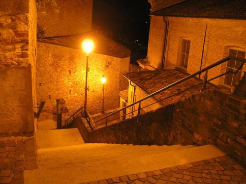 an alley with stairs and a street light at night at Il Borgo B&B in Castellinaldo