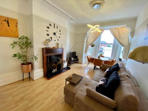 a living room with a couch and a fireplace at Ann Apartments opposite the Pier with sea view in Portsmouth