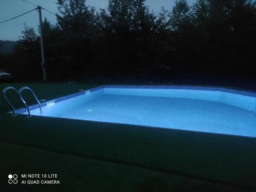 a large pool with blue water in a yard at RIVIERA in Lekechi