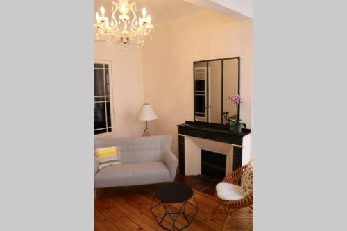 a living room with a white couch and a fireplace at Beautiful T3 Apt in historical Toulouse city centre in Toulouse