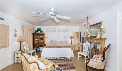 a bedroom with a bed and a ceiling fan at Binky's Summer Afternoon in Fredericksburg