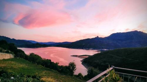 a view of a body of water at sunset at Pé na Aldeia in Outeiro