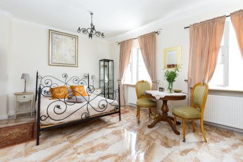 a bedroom with a bed and a table and chairs at Royal Castle Square Apartment Old Town Warsaw Warszawa in Warsaw